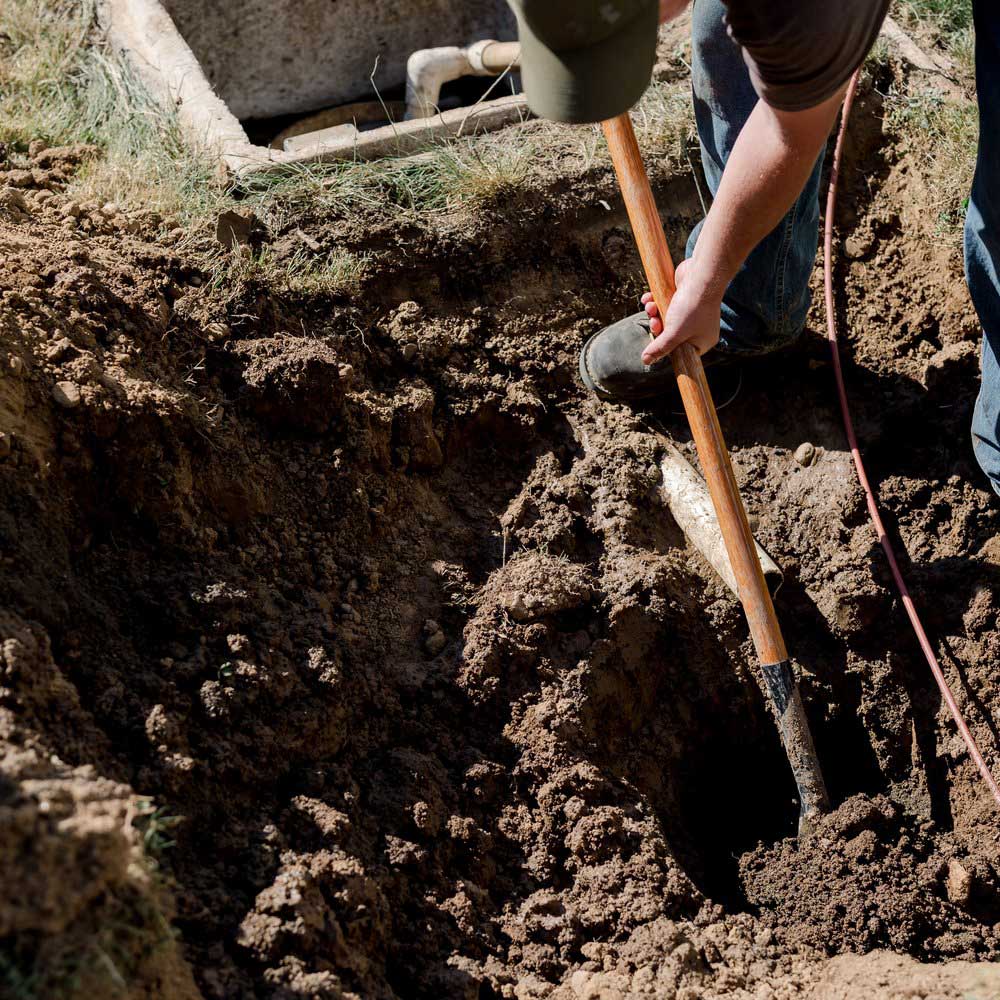 Man digging septic - Goodman Sanitation Septic Solutions in Portland OR