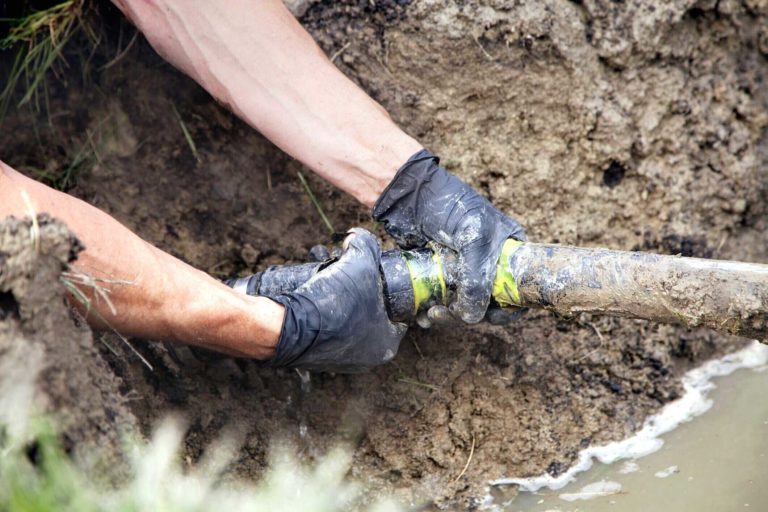 hands repairing septic pipe - Septic Inspections by Goodman Sanitation in Troutdale OR